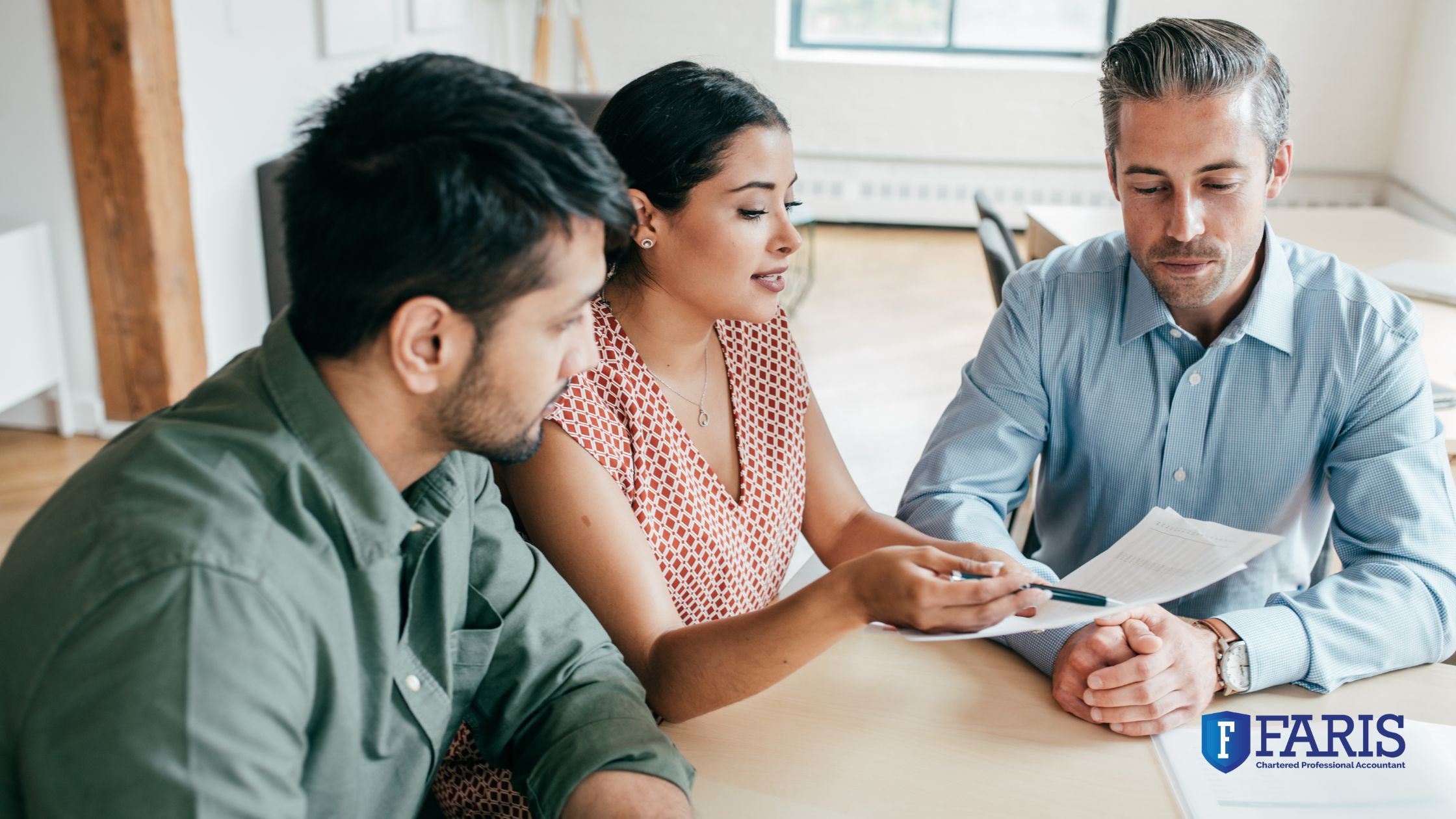 Financial advisor meeting with a couple to explain allowable business investment loss tax options.