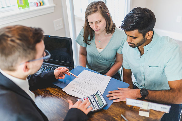 Business partners consult an accountant regarding taxes and business expenses. 