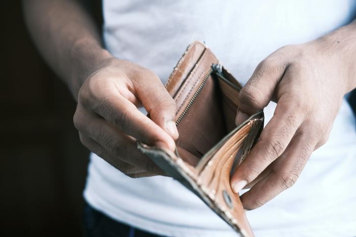 A man opening an empty wallet