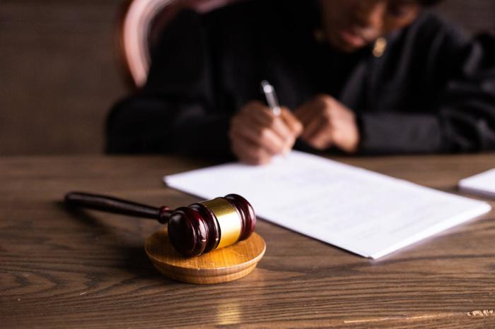 Closeup of a gavel as a judge writes out an order