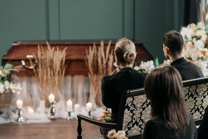 People sitting at a funeral service