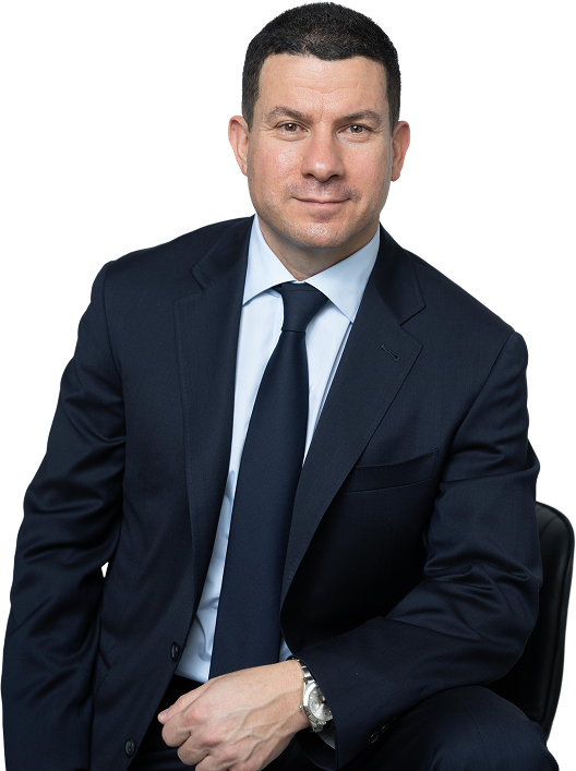 Photo of Sam Faris sitting down smiling