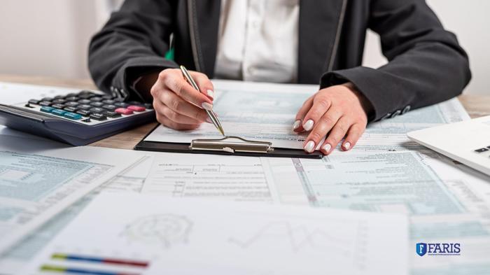 Canadian taxpayer reviewing T1135 foreign income reporting forms with a calculator and financial documents, supported by Faris CPA.